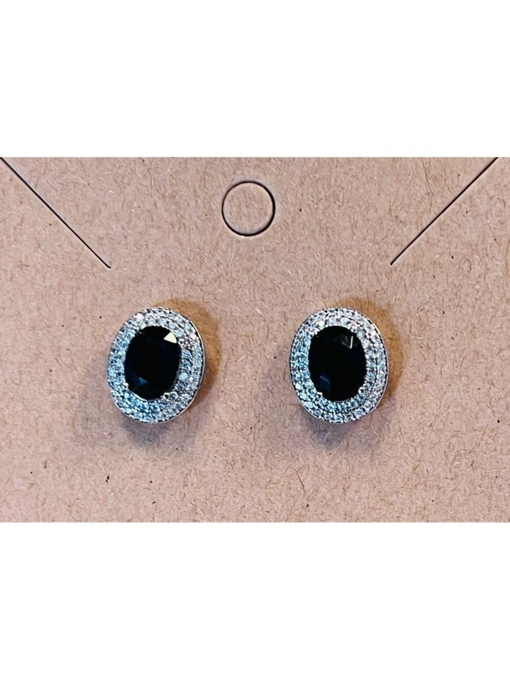 Small stud earrings with black color stone encased with mini CZ type stones.